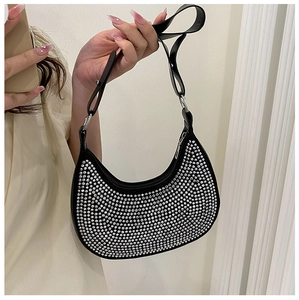 Detail of a black hobo underarm bag featuring shimmering rhinestones and a silver chain strap