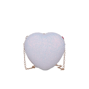 Detail of glittery heart crossbody bag featuring pink sequins and gold chain strap
