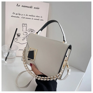 Detail of off-white leather handbag with black gold geometric buckle and chain strap