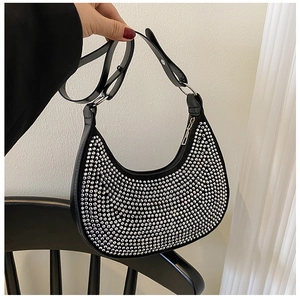Detailed close-up of a black hobo bag with sparkling rhinestones and silver metal hardware