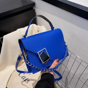 Klein blue women's crossbody handbag with a geometric buckle and chain strap