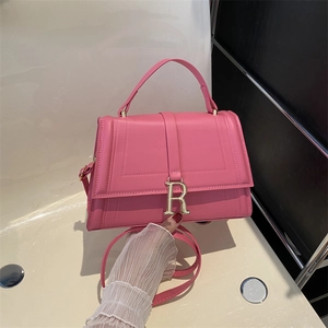Pink fashion handbag with golden R buckle, featuring a top handle and adjustable shoulder strap