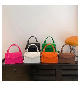 Detail of colorful PU leather crossbody bags with embossed texture and knotted handles