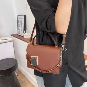Brown leather crossbody bag with gold chain detail and envelope flap for women