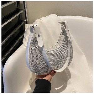 Macro shot of white crescent hobo bag with glittering silver rhinestones and zipper