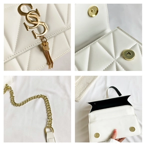 Macro view of white quilted bag with gold V-hardware and magnetic snap button closure