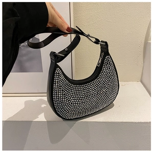 Detail of hobo shoulder bag featuring dense silver rhinestones and a metal zipper
