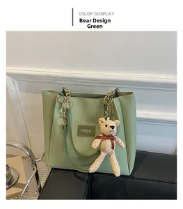 Green large capacity tote bag detail with fashion patch and a cute bear keychain