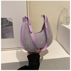 Detail of light purple crescent shoulder bag with sparkling silver rhinestones and strap