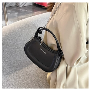 Detail of black hobo bag featuring silver chain strap and white fashion text logo
