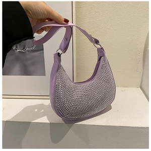 Close-up of a purple crescent underarm bag featuring shimmering silver rhinestones and texture