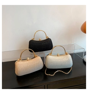 Detail view of sparkly evening clutches in black, gold and silver with rhinestone handles