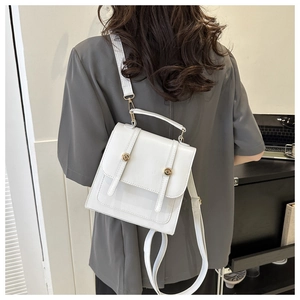 Model back view showcasing a white minimalist PU leather handbag with gold buckles