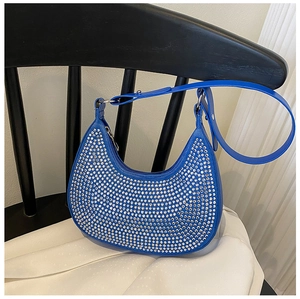 Detailed close-up of a royal blue crescent bag with sparkling silver rhinestones and chain