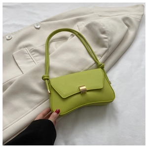 Detail of lime green faux leather shoulder bag with gold metal clasp and knot strap
