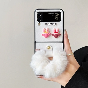 Detail of Samsung Z Flip 6 case with 3D girls motif and fluffy white plush handle