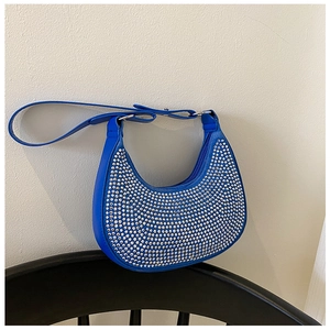 Detail of royal blue rhinestone underarm bag with sparkling crystal mesh and silver hardware