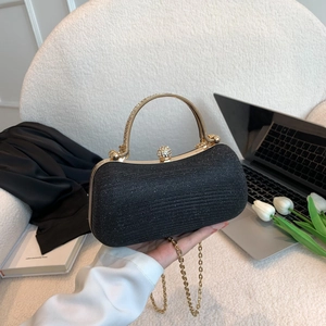 Elegant black glitter evening bag with gold handle and sparkling rhinestone closure