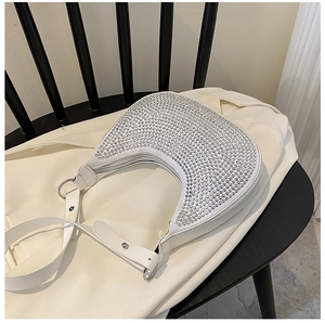 Close-up of hobo shoulder bag featuring sparkling white rhinestones and silver hardware