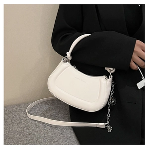 Close-up of a white half-moon bag with silver chain and Fashion & Bags text on leather