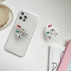 Luxury heart-shaped expanding phone grip with colorful rhinestones and gold text design