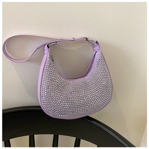 Detail of purple crescent underarm bag with sparkling silver rhinestones and chain strap