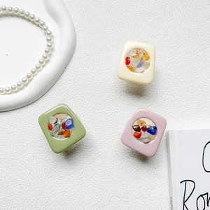 Detail shot of colorful resin phone grips featuring square pastel stones and beads