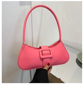 Close-up of pink baguette bag showing smooth faux leather texture and square buckle