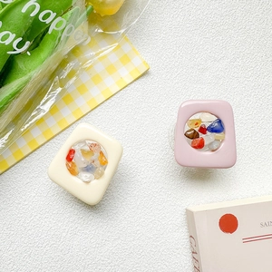 Detail showing square phone grips with colorful crushed stones and tulip decoration