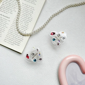 Detail of heart-shaped acrylic phone grip with colorful rhinestones and slogan