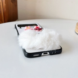 Detail of Samsung Z Flip6 case with white faux fur texture and cute cartoon doll pendant