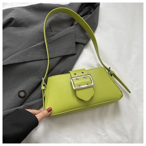 Detail of green underarm bag with large silver metal buckle and retro Y2K design