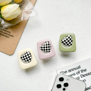 Checkerboard heart phone sockets in beige pink and green colors on aesthetic background