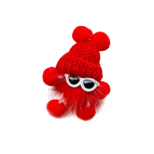 Cute red plush monster phone stand with glasses and knit hat on white background