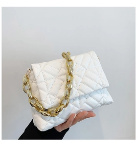 Close-up of white quilted PU leather handbag with decorative thick gold chain link