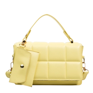 Quilted yellow handbag with a matching small coin purse and elegant gold hardware