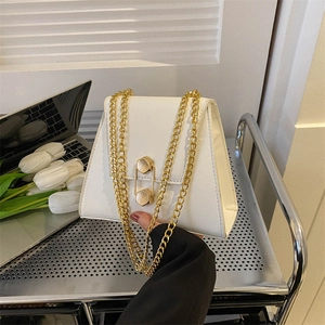 Minimalist white trapezoid crossbody bag with gold chain strap and metal buckle lock