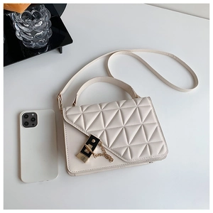 Quilted cream crossbody bag with gold hardware and phone for size reference