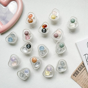 Detailed macro view of resin phone grips with pearl and gemstone in Korean INS style