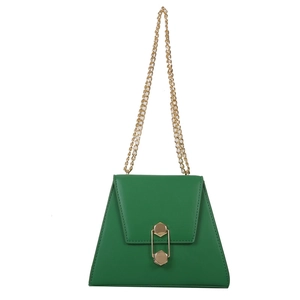 Trapezoid green leather handbag with gold hexagon lock and chain strap on white background