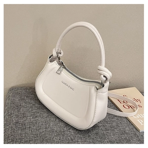 Detail of white crescent bag showing knotted handle and adjustable shoulder strap
