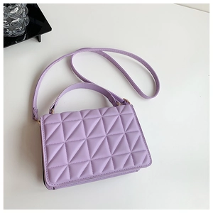 Detailed top view of lavender quilted shoulder bag with triangular textures and shoulder strap