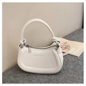 Close-up of white PU leather crescent bag with knot handle and silver fashion lettering