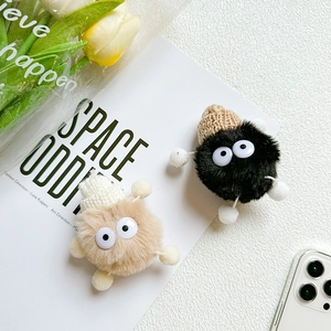 Close-up of cute plush devil phone sockets in black and beige with knit hat details