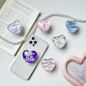 Collage of heart-shaped resin phone grips with floral designs and inspirational quotes