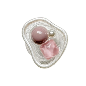 Artistic open ring featuring purple bead, pearl, and pink stone on white background