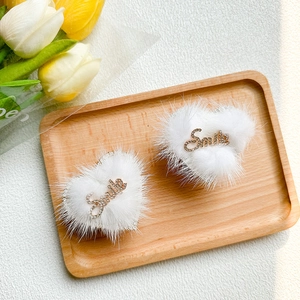 Detail of plush heart phone sockets with Smile rhinestone lettering on wooden tray