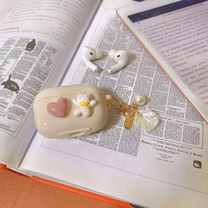 Cute cream AirPods Pro case featuring 3D pink heart, cat charm, and pearl shell keychain