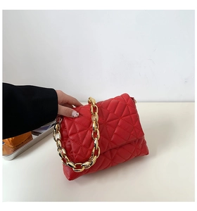Detailed view of red quilted PU shoulder bag featuring thick chunky gold chain strap
