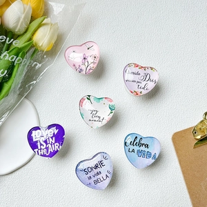 Set of six heart-shaped crystal glass phone grips with various floral and quote designs
